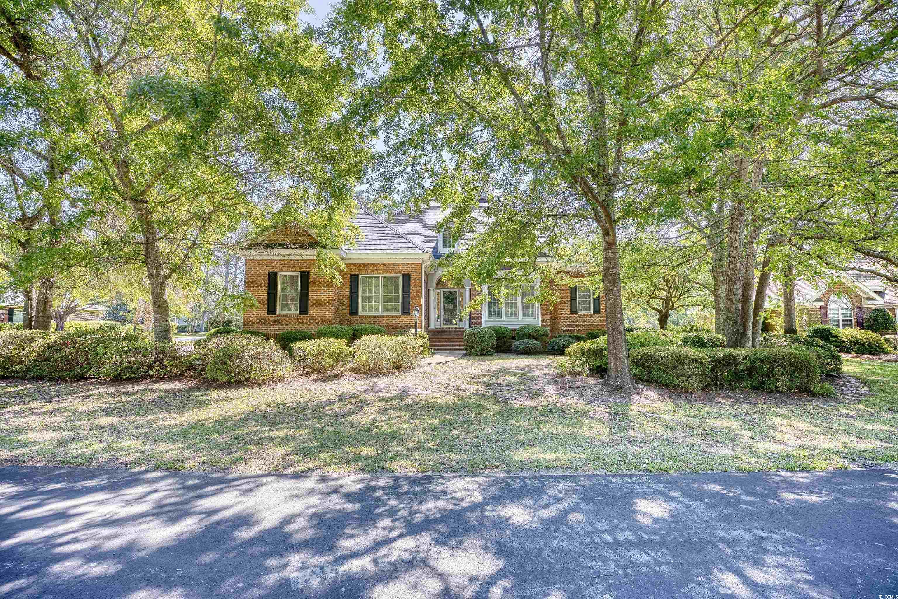 welcome to the sought-after neighborhood of river club with full access to litchfield by the sea. this all-brick home sits on a corner lot over a 1/3 of an acre landscaped by oak trees and azaleas cascading in front of the home that blooms in the spring. you will also notice as you walk to the front door across the street is a view of the pond and golf course. upon entering the home you'll fall in love with the tall ceilings and natural light, and immediate views of the wooded, private back yard, which has a pond view to the right side of yard. enjoy a late day beverage on the screened in porch or on the deck. the formal dining room gives you more space for holiday gatherings, and the living room directly in front of you boasts a fireplace for those cozy winter nights. so much room! and the kitchen is extremely open and spacious with natural lighting and a large family room/sitting area for more entertainment. lots of cabinet space, a walk-in pantry and granite countertops make this a chef's dream kitchen. the other side of the home has three bedrooms. the spacious master suite is on the first floor and brings in the morning sun, with a walk-in closet and a full bath. there's an additional linen closet in the hallway. and travelling down the hall are the other two bedrooms and a shared bath. the fourth bedroom is located upstairs with a full bath and closet. the walk-in attic gives you additional storage for all those extra holiday decorations! this is truly a well-built home that has shared many, many family memories, and you can make them yours too. this home must be seen to be appreciated--schedule your showing today! thank you.  river club is a gated golf course community with a private pool and access to litchfield by the sea. there is a private pool with restrooms, tennis courts, and pickle ball courts. just minutes to beautiful beaches, marina, shopping, world class golf courses, state park and more. only 20 miles south of myrtle beach and just one hour north of historic charleston.