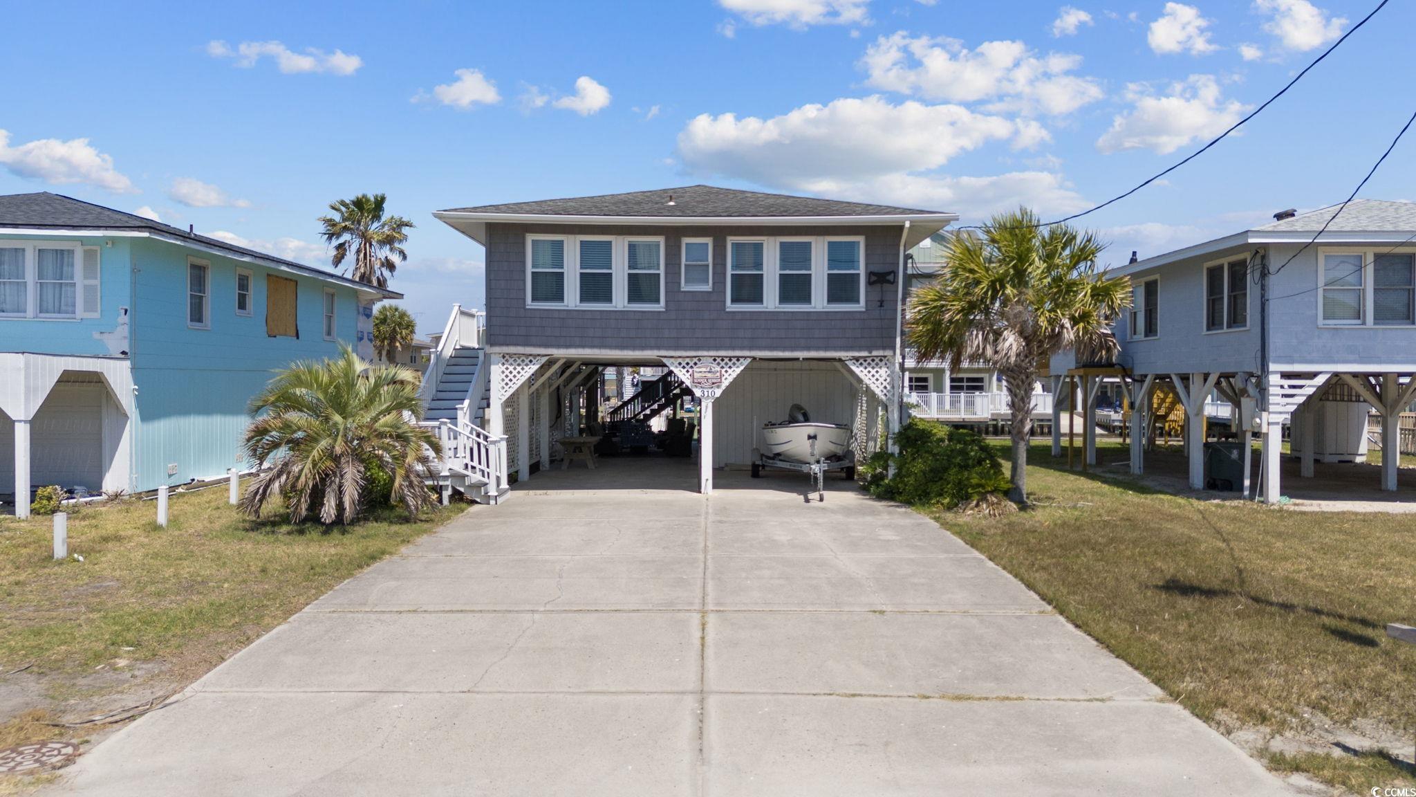 wow! check out this one-of-a-kind channel home in cherry grove with magnificent water views. this four bedroom, three and one half bath home is only two short blocks from the beach. offering a very unique floor plan with two large living spaces, an open kitchen, and split bedroom layout. experience the convenience of effortless access with your own elevator. this home truly caters to your every need. the allure continues as you enjoy serene water views, allowing you to unwind from the comfort of your home. exterior features include floating dock and two large storage rooms. whether you seek a tranquil vacation retreat or an investment property with excellent rental potential, this residence fits the bill perfectly. make this slice of paradise yours today!