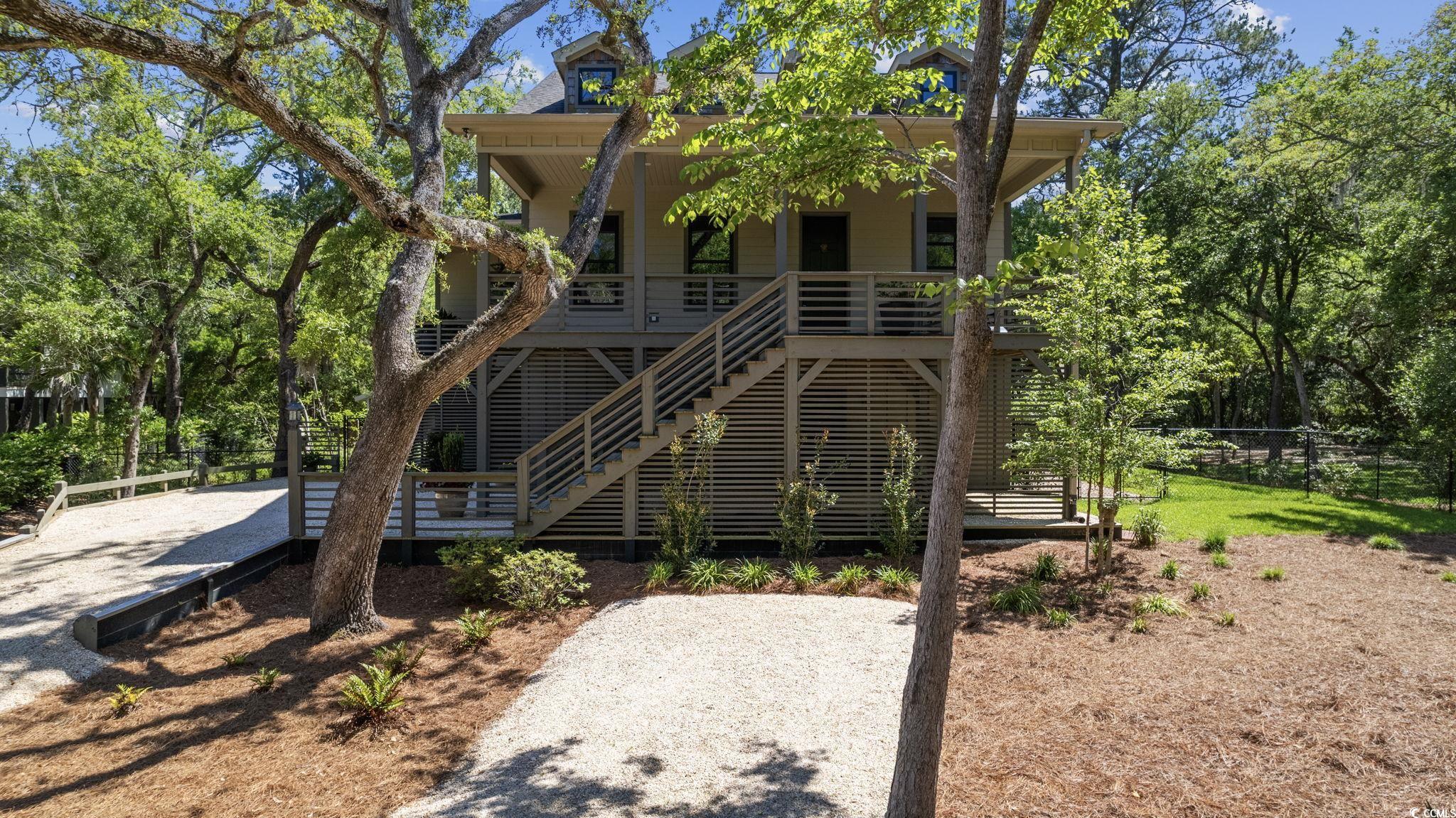the beach is calling, and you must go! this stunning elevated beach house in pawleys island is a true custom build, completed recently in 2020. this modern coastal design is loaded with luxury finishes, quality craftsmanship, and impressive features with every corner you turn. it features 4 large bedrooms, including dual owner's suites on the primary level, and 3 full bathrooms. located on a expansive .67 acre lot on a quiet street in a small neighborhood filled with custom homes and no hoa, overlooking the inlet with the sounds of the beach in the distance; a true hidden gem tucked away yet close to all that the grand strand has to offer. coming in at 2,830 square feet this home has tons of space for living the retreat lifestyle. step inside the welcoming wide foyer, adjacent to the living room with tall vaulted ceilings and windows for all the natural light you could dream of. you will be immediately impressed upon entry with the luxury design this home offers. a flowing floor plan that provides the ideal setting for hosting gatherings with your family and friends, while also giving a sense of function and tranquility. beyond the living room, you will find the formal dining room, and the secondary owner's suite with it's own bathroom. the gourmet kitchen complete with two-toned complimenting granite countertops, stunning steven shell pendants, pristine fixtures, gas stove, african wood stained island, and walk-in pantry. tucked away on the primary level is also the massive owner's suite that is sure to knock you off your feet...the feel of living in your own personal luxury resort that you so luckily get to call home. upstairs you are greeted by a wide loft, two additional spacious secondary bedrooms, and the third full bathroom. each space, so full of charm, modern touches, and an overwhelming sense of tranquility.   noteworthy finishes include wide craftsman trim throughout, wide window sills, 10 foot ceilings, 8 foot doors, 2x6 exterior walls, custom lighting throughout including steven shell living pieces, natural wood floors that are sealed, anderson black-trim windows, and a framed-in elevator shaft. the details in a home matter, and this one truly has it all.   venture outdoors to the expansive covered porches overlooking the mature oak trees, the sounds of nature, and the breeze of the nearby ocean. exterior features also include the fenced in backyard with lush landscaping, covered parking and storage areas, and so much more. the bottom level of this home is completely finished in providing a huge closed in shop/work space, and garage parking. pawleys island charm stems from its highly ranked pristine beaches, and casual laid-back lifestyle. it is home to an abundance of outdoor activities, premier golf courses, rich history, and an array of amazing restaurants. grab your beach towel or your fishing pole, and head home to pawleys island. schedule your showing today on this remarkable, one of a kind, home!