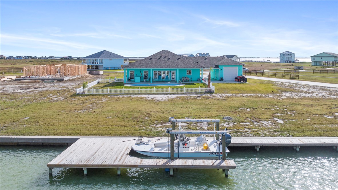 CANAL FRONT | DIRECT TO BAY FISHING | BOAT LIFT | POOL It is everything you have ever wanted from your Rockport Retreat. Newly constructed w attention to detail, this custom waterfront home is ideal for Coastal Living. Every aspect of this home is thoughtfully laid out. Almost an acre, sunsets to die for. The driveway leads to a detached, 16’ 4” x 32’ 10” boat garage w 12’ ceilings & double garage doors- Breezeway too!The covered front porch is expansive. Once inside the open floorplan is perfect for the enjoyment of exceptional water views. An island kitchen, HUGE pantry & utility room unexpected, make sure you take the time to enjoy all that storage! Double oven, SS appliances + lots of counterspace will make cooking a dream. The master retreat is spacious w double sink & a walk-in shower is private & cozy. Pool & covered back porch with outdoor kitchen, boat slip, 5'x15' dock & 10,000lb boat lift complete the package. Take a moment to witness the sunsets and the wildlife!