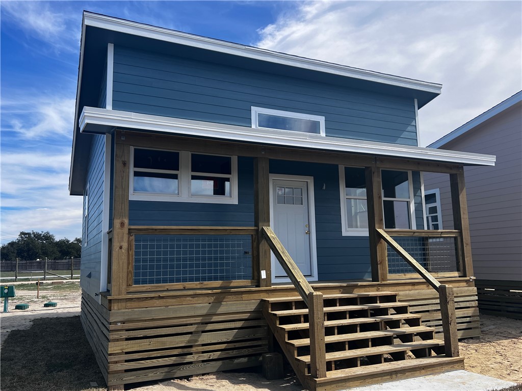 New Construction under $200k in Rockport! Ready by 4/1, This luxury living tiny home was designed for comfort & sensational style. Imagine a day on the water and coming home to your easy living cottage with luxury vinyl floors, 14' ceilings and plenty of space to relax. The roomy bathroom has a tiled shower/tub, double sink vanity and black hardware finishes. The open living concept makes great space & you'll love the kitchen with its modern soft close cabinets, level 3 quartz counters, rolling island, 36" double basin stainless sink, tankless water heater, and stunning tile backsplash and hardware. Both bedrooms have access to the spacious back deck. Kayak & toy storage underneath. Built up to Windstorm regulations with 2 x 6 construction, foam insulated walls, ceiling and foundation. Climate control in each room & full laundry. TWIA insurable & financeable. Rockport's Newest Best Tiny Luxury Living Community! GPS 2351 W Market. Google hasn't found us yet. Short-term Rentals Allowed