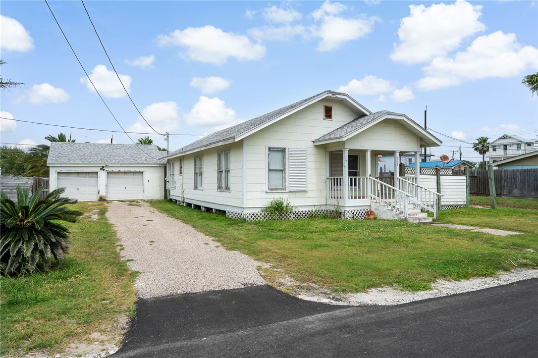 INCREDIBLE INVESTMENT OPPORTUNITY in the heart of Port Aransas. Huge homesite within walking distance from the beach, amazing restaurants, entertainment, and more. The main house has that old-time charm and uniquely designed with 3 bedrooms, 1 full bathroom, kitchen w/a bar and breakfast area, large gathering Rm at entry, huge bonus room, and laundry room. The detached 2 car garage has lots of storage, an attached hobby room, and a long driveway with lots of parking space. The private backyard is shared with a one bedroom, one full bath guest house. There is so much potential sitting on this .21 acre property. Knockdown and build or Refurbish the main house while living in the guest house. This amazing property is priced under the NCAD Value, and Short-term rentals are allowed. See it today and don't let this one get way!!!