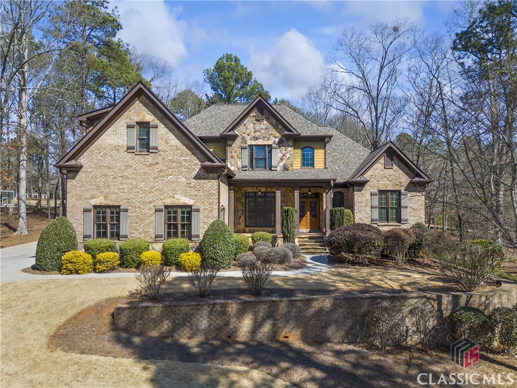 No detail is overlooked in this beautiful, spacious custom-built builder's home tucked between the #15 green and #16 tee box in Oconee County's highly desirable Lane Creek Plantation.  This 5 Bedroom, 4.5 Bath gem is loaded with space and has plenty of extras, starting with the flagstone front porch, tongue and groove stained wood ceiling, and stained french doors that greet you as you enter into the foyer.  The formal dining room has shoulder height picture molding, two piece crown molding and a triple window that overlooks the large, rolling front yard.  There's also a powder room just off the front entryway with custom vanity cabinet and dark painted trim.  The great room has soaring high vaulted ceilings with crown molding, built-in cabinets with wet-bar and a gas log stacked stone fireplace. The large family gathering area is completely open to the kitchen and large breakfast area that offers the space to be used in many different ways. The main floor common areas are equipped with real site finished hardwood floors along with 12" base molding. The kitchen has custom built stained cabinets with a painted cabinet island. Granite counter tops, tile backsplash and stainless steel appliances with double built-in ovens are other features this incredible kitchen has to offer. Off the kitchen is a large mudroom with laundry hook-ups, a sink and an exit/entry point to and from the exterior. On the opposite side of the house is the enormous master bedroom with a trey ceiling and windows overlooking the #15 green. The master also has a door that leads to the covered porch for easy access to enjoy the sunrise over the course. The master bath is very spacious with separate dual vanities, a completely enclosed tiled shower and a jetted tub for relaxing and easing the stress from the day. The large walk-in closet is partitioned into 2 sections perfectly set up to offer any couple ample space for all your seasonal clothing. Upstairs are 3 large bedrooms and 2 full bathrooms. One bedroom has its own private bathroom and an enormous walk-in closet. The other 2 bedrooms are very spacious and offer great closet space and share a large hall bathroom. The downstairs terrace level is where all the fun happens...set up with a media/rec room perfectly situated for your kids to have their friends over and enjoy their favorite games. The terrace level also features another large bedroom, walk-in closet and full bathroom with tiled shower, as well as multiple unfinished areas for plenty of storage. If you're looking for great outdoor space you've found it here with the back porch covered by a stained wood vaulted ceiling. Off the porch is a stamped concrete patio which together offer multiple outdoor lounging areas. These areas are enclosed by an ornamental courtyard fence that also consists of a fire pit for enjoying early evening smores as the sun sets over the #16 tee box. This home is wired for speakers throughout the main living areas including the great room, kitchen, basement media/rec room, bar and outside on the covered porch so wherever you are you can enjoy surround sound movies/ballgames or listen to your favorite artists. Last but not least is the large 3 car garage that offers additional parking to accommodate the whole family. Lane Creek Plantation is located in the heart of highly desirable Oconee County and districted for the award winning North Oconee School district. Call today to schedule your time to see this incredible home.