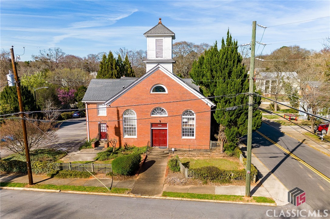 Rare opportunity to own a piece of In-town Athens history. This late 1800s church compound was converted into 10 condos within 3 brick structures, winning a Historic Preservation Award. Located within blocks of Downtown and UGA, as well as multiple parks, the Oconee River, the ever-expanding Greenway and Firefly Trails, this is Athens' most green-centric in-town neighborhood. The 2-story, 3/2 condo has a modern interior aesthetic, with exposed metal rafters and ductwork, 20' ceiling with skylight in common living area, a stylish kitchen with large island, stainless appliances, and pantry. There's a small, privacy fenced courtyard off this common area. There's a large bedroom and bath on main floor, with 2 generously sized bedrooms with an artfully designed 2 room bath upstairs. One of the upstairs bedrooms has french doors with views that overlook the common living area below; this room could be used as an upstairs loft living area, office, den, art studio, if a 3rd bedroom isn't needed; it allows for a great flex space. Ultimately, this community, Chicopee Commons, is a very unique mix of historic and modern elements, in a well landscaped setting, with parking areas available off both Arch and E Broad Street, and is about as close to Downtown or UGA's main campus as one can be, allowing one to easily access/enjoy all of what makes Athens a desirable destination.
