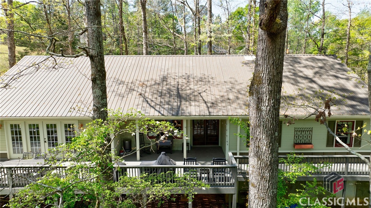 This beautifully renovated and meticulously maintained home sits on 2.8 acres in a private park-like setting with a view of a creek, yet is just minutes away from Watkinsville, UGA, and Athens. You will not find a more inviting home, on such a gorgeous lot, with finishes as detailed as this home anywhere in Oconee County.  Spacious rooms and living areas, luxurious bathroom and kitchen upgrades, and exceptional outdoor spaces make this home a must-see. The upgrades are numerous, but a few notable ones include the exterior: a large 1050 square foot wrap-around deck and a 100+ square foot covered porch, a recently installed metal roof, new Hardie wainscot siding and trim, high-quality PELLA windows, new gutters, beautiful stained front patio doors, fresh paint, and charming outdoor lighting for evenings on the deck. Inside, almost every inch has been transformed. The kitchen boasts new appliances, granite countertops, custom tile backsplash, and under-cabinet lighting. The bathrooms have been remodeled to a magazine-worthy standard, with high-end door hardware, lighting fixtures, and bath accessories adding the finishing touches to this exquisite home. If you are in search of a home with unparalleled beauty... this is it! 

The convenient location of 1201 Great Oak Lane in Watkinsville, GA offers easy access to top-rated Oconee Co. schools, shopping, Wire Park (2.5 Miles), OCAF, Downtown Watkinsville and more. With such a prime location, you'll have everything you need right at your fingertips. The proximity to Athens loop also provides easy access to all the amenities the area has to offer in the Classic City of Athens,GA inc. the UGA campus (15min.). This property truly offers the perfect of suburban living with easy access to city conveniences.