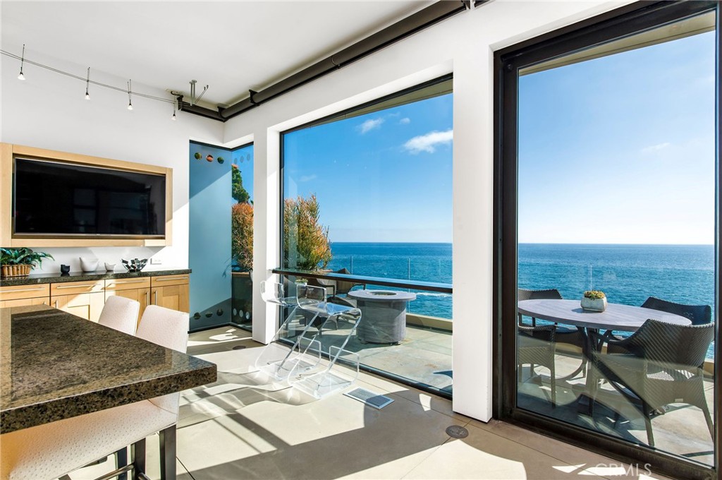 Intimate Primary Suite with oceanfront balcony with sunset and Catalina Island views.