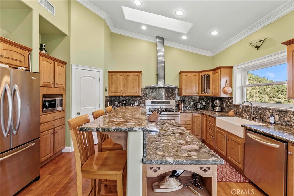 Level 1: Gourmet kitchen, center island and stainless steel appliances, and farm style sink.