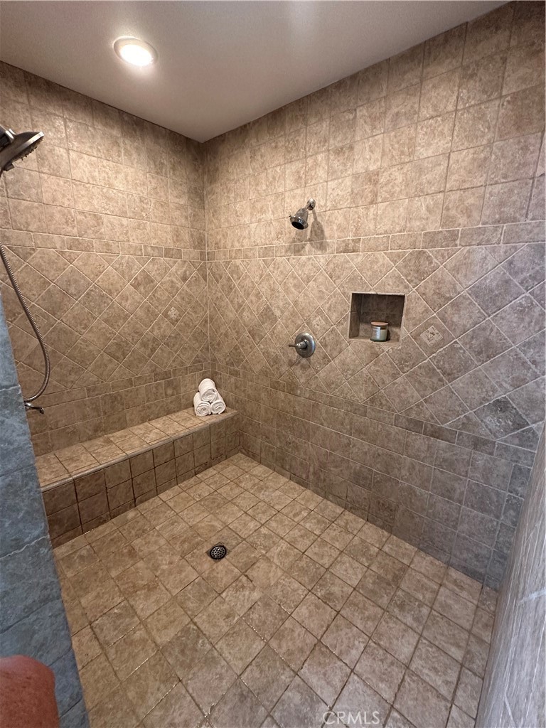 Walk in 5.5x8 ft Shower with 2 shower heads and a sitting bench