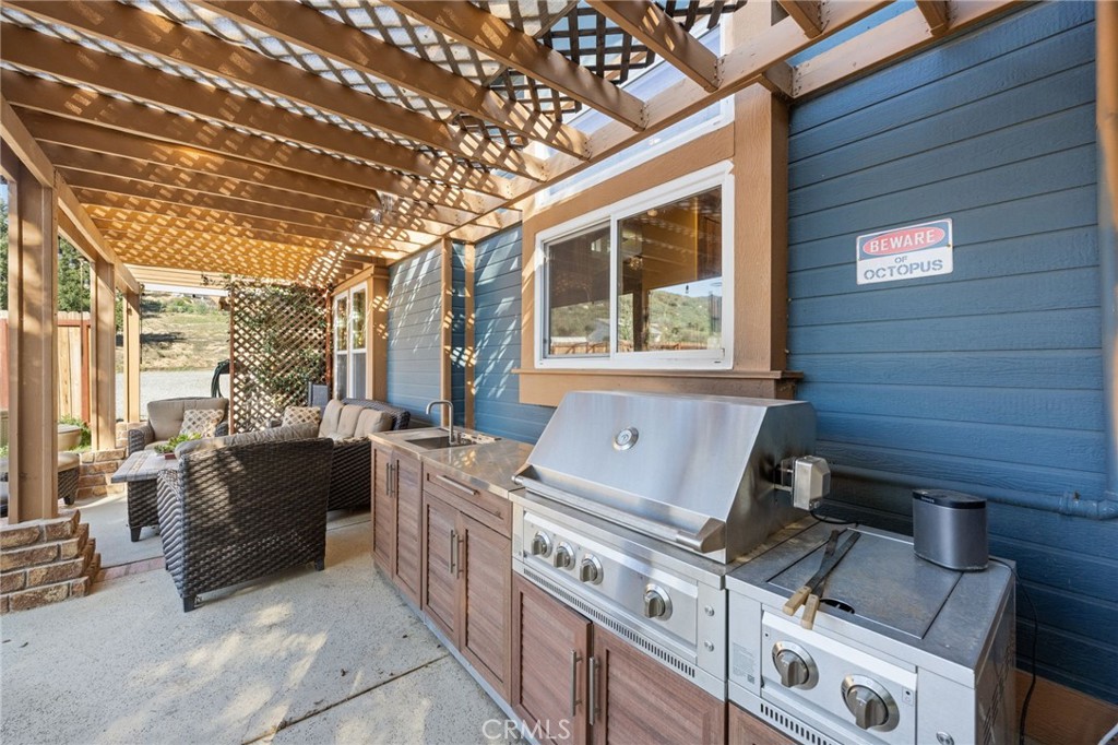 Outdoor grilling area and wet bar, near the pool, and off the kitchen in the Main House.