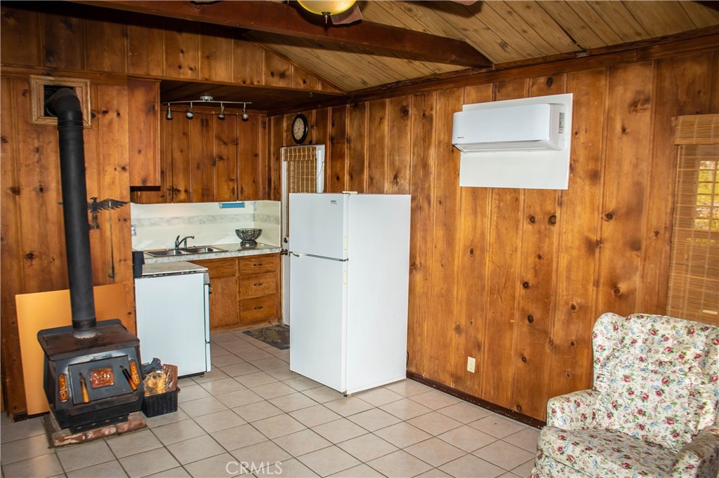 Guest house with kitchen including reconditioned counters, newer backsplash, refrigerator, range and oven.  Also includes a free standing wood burning stove and mini split AC.