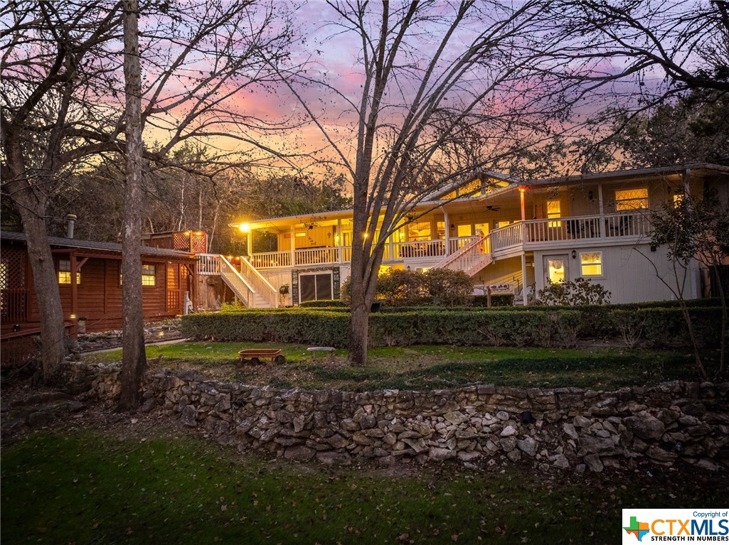 Escape to the serene beauty of the Texas Hill Country with this enchanting and idyllic property nestled along the picturesque Guadalupe River. This charming and romantic retreat offers a unique blend of luxury and tranquility located less than a mile from Historic Gruene in New Braunfels, Texas. As you arrive at this riverside oasis in desirable Preiss Heights, you'll be greeted by a 5100 sq. ft. (+/-) residence boasting 103 ft (+/-) of pristine Guadalupe River frontage. Whether you seek a private sanctuary for personal residence or envision continuing its legacy as an inviting inn or B&B, this property seamlessly accommodates both aspirations. Step inside to discover eight uniquely decorated guest rooms, each exuding its own European character and style. From luxurious linens and robes to modern amenities such as TVs, mini-refrigerators, and wireless internet, every detail has been carefully curated to ensure comfort and relaxation. Some rooms even feature spa tubs and fireplaces, providing an extra touch of indulgence. Outside, the enchanting landscape beckons with its serene ambiance and captivating views of the Guadalupe River. No matter what you do on this property you will be enveloped by the natural beauty that surrounds you. This location offers unparalleled convenience and access to a myriad of recreational activities. Whether you envision running your own inn as a lucrative investment opportunity or creating your dream personal residence, the versatility of this property knows no bounds.