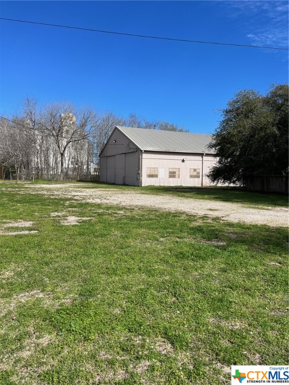 This building has a warehouse with large doors on both ends and tall ceilings. It also has an area that can be used for office space in front. The building has 2 additional lots being sold together. Following are the 3 property ID's 25402, 25403, 25407.