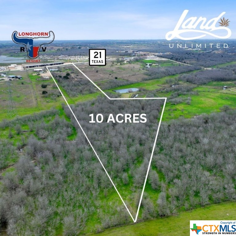 Highway 21 Development Opportunity! 10 acres right across from Longhorn RV Park. Very high traffic area in a booming location outside of Kyle TX. There is an 8 in Goforth water line at the road. A mobile home in fair condition will convey and all utilities (septic/water/electric) are connected. No deed restrictions however 2 acres are in the City of Niederwald. Buyer to confirm development use with City and Caldwell County. Partial flood plain in the back.