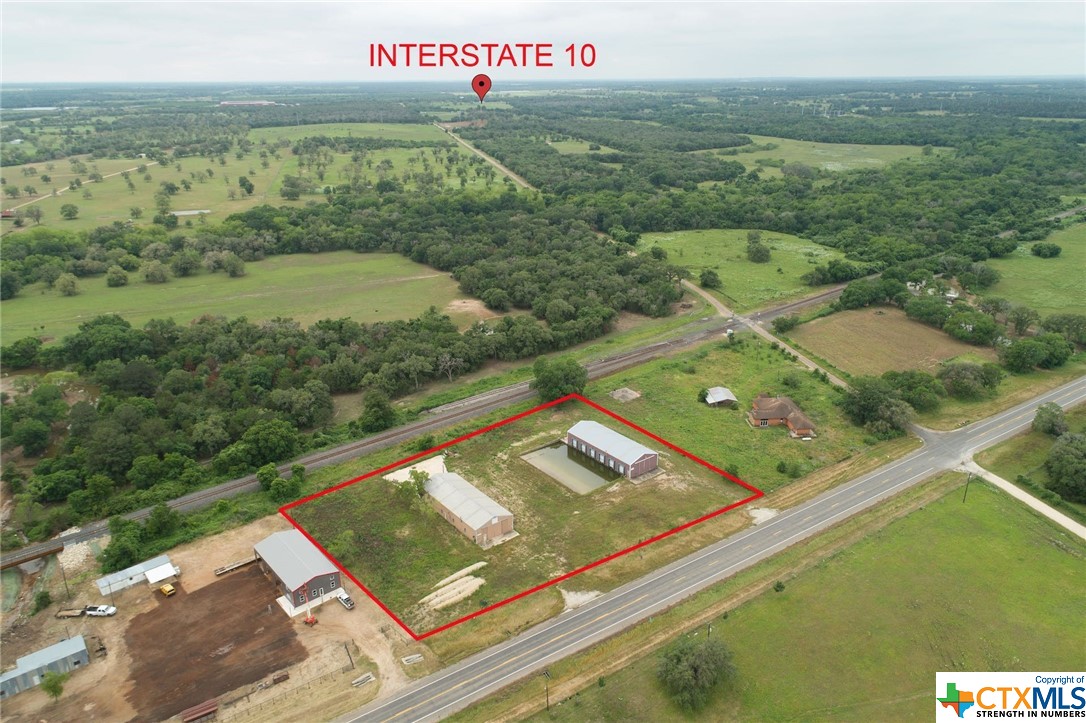 2.24 acres with two metal buildings. Both buildings have cement floors, 26 ft high ceilings and approx 4000 sq ft each. There are 6 below grade loading docs. This property is located just off IH 10. One hour from San Antonio and Austin. 2 hours from Houston.