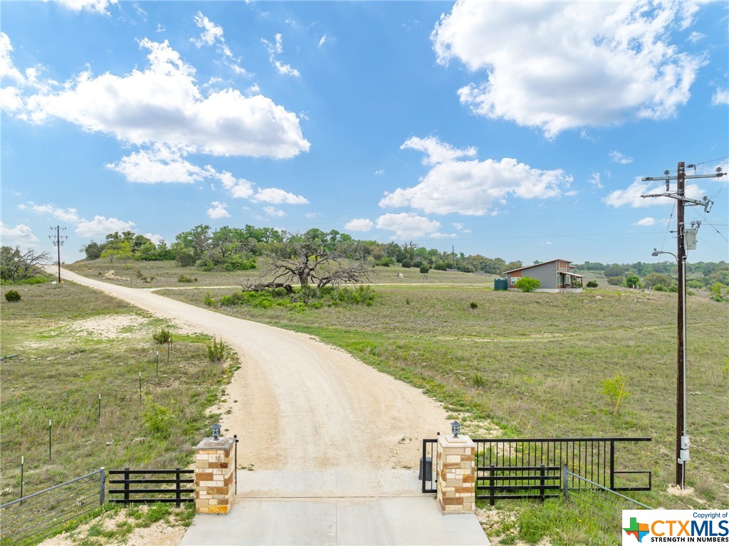 ***SELLER IS MOTIVATED*** Located within the serene Hilltop Springs Ranch, this remarkable 10.29-acre parcel offers breathtaking views and tranquil surroundings in a GATED community. With light deed restrictions in place, the property welcomes the construction of custom homes or barndominiums. Boasting an agriculture exemption, mature trees, beautiful views of the Texas landscape and an electric meter already installed, this land provides the perfect canvas for creating your dream residence or countryside retreat. Additionally, it features a well with its own well house, a 2,500-gallon storage tank, and a pressure tank, offering self-sufficiency and convenience for water supply needs. Horses are welcomed, and the Property Owners Association diligently maintains the roads, guaranteeing year-round accessibility. With a focus on residential living and a prohibition on commercial activities, this property promises a lifestyle of unparalleled serenity and charm, harmonizing natural beauty with modern convenience in a truly picturesque setting. Schedule your showing today!
