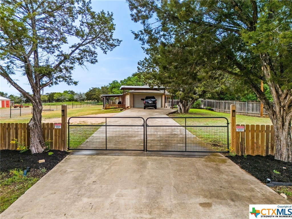 Rare opportunity to own horse property at an amazing price! Everything is already set up with horse stable that has 3 stalls, electricity and water/wash station. Situated on 2.7 acres, this home offers an open and functional floor plan, kitchen with breakfast bar, plenty of cabinet and counter space, wood look tile floors and wood burning fireplace in the living room. Enjoy a glass of wine or cup of coffee on the open patio that can be accessed from the living room as well as from the front entrance or relax on the covered deck off the dining/kitchen area enjoying the view. One smaller bedroom is currently used as an office, the other of the 2 secondary rooms is larger and in the back of the home. The primary bedroom is also located in the back of the property with updated modern ceiling fan and the primary bath offers a separate shower.  Grow your own vegetables in the raised bed garden that's set up behind the home. This property has been loved and enjoyed by its owners and is ready for you. Low tax rate! Saddle up and make this your new home!