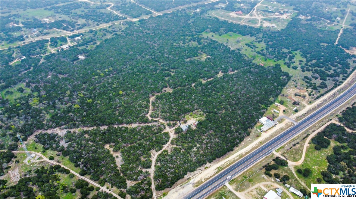 577 Linear Feet of Highway Frontage!
Nestled within the serene hill country, this captivating 68.69-acre property is a sanctuary of natural beauty and opportunity. Boasting two barns and three hunting blinds, it's a paradise for outdoor enthusiasts. With ample frontage along Highway 281, accessibility is unmatched. The entire perimeter is securely fenced, providing both privacy and safety. The expansive cleared areas offer endless possibilities for agricultural pursuits or recreational activities. What's more, being wildlife exempt and unrestricted, this property holds immense potential for commercial ventures. Located in the county, it also offers the tantalizing option of subdividing, providing a rare chance for investment and development.