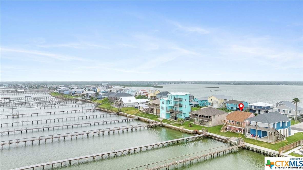 Experience waterfront living at its finest in this charming 2 bedroom, 2 bathroom bayfront Copano Ridge home.  Enjoy spectacular sunsets from your back deck & private pier or launch your kayak from the private ramp.  Recently upgraded with new exterior siding & fresh paint both inside and out, this home is move-in ready.   It is also being sold fully furnished with the most adorable coastal decor.  The interior features a large bar in the kitchen for entertaining, an open floor plan, & split bedrooms for added privacy when you have guests.  A spacious upper deck, a nice sized yard, & a covered patio area gives you all of the outdoor space you will need to enjoy those coastal breezes and take in that fantastic view!  This home offers convenience to all that Rockport has to offer, as it is only minutes away from the beach and local shops and restaurants.  Short and long term rentals are allowed if you are looking for an investment property.  Come tour this amazing waterfront home today!