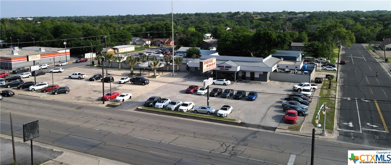 Rare commercial opportunity in fast growing Killeen. Owner is occupying the main dealership and lot on a lighted corner. Building has a new roof, 6 offices, there is a safe (building was a bank when built) breakroom, and kitchen area. Tile flooring throughout the main area. Owner will either vacate at closing, or is willing to sign a 3 year gross lease at $7,000 per month, no NNN's. There are an additional 2 tenants leasing 2 buildings on parcel 80574 and parcel 7608, combined lease amount of the 2 tenants is $2700.00 monthly. There is an older residential structure on the property that would need to be demolished at some point, it is not habitable. This is an entire block with city street on all for sides. Please do not disturb any of the businesses, make an appointment for a tour.