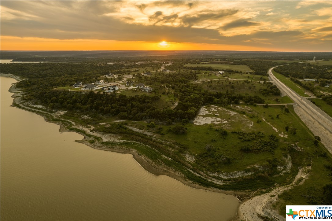 Enjoy the serenity of the country with the convenience of town just down the road. Expansive lake and hill country views await you in your backyard oasis. Just fifteen minutes from downtown Temple and 20 minutes to downtown Belton, you can build your own haven in the Hill Country while staying active in the vibrant community life that Central Texas offers. Make the most of lake-living with a boat ramp accessible just across the Highway 36 bridge and ample access to hiking trails. Located inside Belton ISD, Enclave is just a short drive (less than 10 minutes!) from Lake Belton High School. Lots available for custom build with no timeline requirement to start! No city taxes means your dream home is more affordable in Enclave. All of our lots range from just under 1 to almost 4 acres, creating a unique and custom feel that will provide character for years to come. With room for a separate garage or shop and guest/pool house all built in the same style and materials as the main house, this luxury estate lot accommodates all needs without compromising the serenity of this gated community. This lot in
particular provides one of the largest building sites in the whole subdivision with lake views to the south and canyon views to the west. The steady slope down the backside of the hill makes this lot special.  Imagine adventures paths down into the canyon with acres of wildlife below and miles of views from the hilltop on your back porch or pool!  Call or text to set up your tour today!