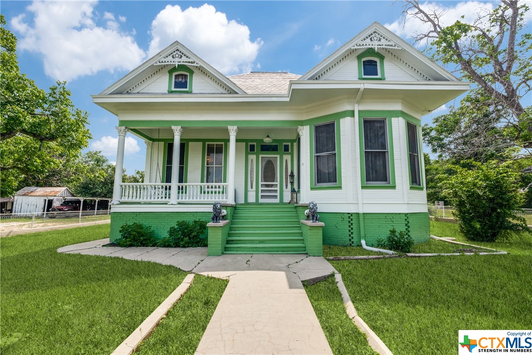 Nestled in McQueeney, Texas, this exquisite 1930 Victorian home seamlessly blends old-world charm with modern convenience. Meticulously restored in 2000, this property offers a unique opportunity as both a residential and commercial listing.
Original Victorian features include wood sash windows, sweeping staircase, grand wood railings with turned spindles, and high ceilings lending an air of spaciousness to the living areas. Antique chandeliers complement the wood-burning stove, creating a cozy atmosphere on chilly evenings. Original doors, trim work, and wood floors contribute to the home's historic charm.
Boasting three bedrooms and two bathrooms, this home provides ample space for comfortable living on its .704-acre lot, perfect for outdoor activities or potential commercial ventures. Situated near Lake McQueeney, it offers abundant outdoor recreational opportunities. Two 50-amp RV hookups cater to adventurers seeking a convenient home base.
A detached carport and covered outdoor area provide convenient parking and a space to enjoy the outdoors. The property includes a storage/laundry room building with electricity and water, ideal for tools or equipment.
With basement possibilities for future development like a wine cellar or speakeasy, privacy is ensured by a fully fenced property, with no HOA restrictions, offering freedom and flexibility for buyers.
Recently painted, the exterior exudes a fresh and inviting appearance, accentuating its Victorian aesthetic with colorful green and white paint and ornate architectural details. The front porch, the bay window and decorative gingerbread trim brings you closer to nature while enjoying the comforts of home.
Furnishings are negotiable, allowing buyers to personalize the home. Now is the time to own your own Victorian-style house, standing apart from the rest.
 Schedule a private showing today to fulfill your dreams.