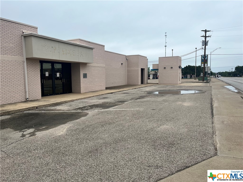 Large brick building (previously Cadence Bank), corner lot of US Hwy 183 and Main Street (FM 581), Lometa.  Purchase will be subject to property not being utilized as a bank, mortgage company, check cashing operation or any banking affiliated capacity for a period of five (5) years from date of transaction.  Great location for a business, has a large parking lot, drive through windows, small building used for ATM in the past.  US Hwy 183 is a busy thouroughfare connecting Austin to Brownwood.   Building is large with 6475 +- sq. ft., multiple offices, restrooms, kitchen area, large conference room, work room, 2 vaults, 4 separate entrances, could house a variety of office and retail space.  Plenty of parking.  Would be a great location for a restaurant venue.