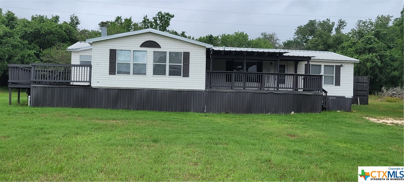 Nice recently remodeled triple wide Manufactured Home on 2.66 acres less than 2 miles from Luling off of Hwy 80.  Home has 2 decks with one covered, a outside storage container and a water well.  There are 3 bedrooms with closets and a 4th room as a second living room or bedroom. Main living room has a wood burning fireplace, and good size utility room with washer and dryer that convey with the home.