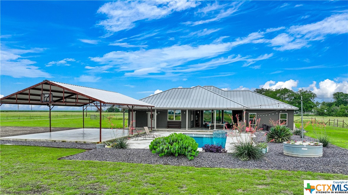 Capital Ranch Sales is excited to present Barbarossa Ranchette, a picturesque homestead in between New Braunfels and Seguin. Upon entering the automatic gate is 11.91 acres fully fenced and cross fenced separating the improvements from the back pasture, currently under ag valuation.  Sitting within the front fenced portion is a custom built 2700 sqft house with 4 bedrooms and 2.5 bathrooms, outdoor kitchen, and custom gunite pool and spa . In addition to the beautifully thought out home, is a 30’x40’ Metal Carport, complete with a concrete foundation. Adjacent to the home is a 50”x60’ Metal Building featuring three overhead doors and two enclosed rooms for the next owner’s canvas of ideas. 

Improvement Details: 
2700 Sqft custom home completed in Spring of 2018, with stained concrete floors adorning every inch, granite counters in the kitchen, and lofty 12 ft ceilings, accentuating the grandeur of the living, kitchen, and dining spaces. Cozy up by the electric fireplace, while looking through the windows to the East towards the pool and open pastureland. Above, a standing seam metal roof crowns the residence, a testament to both style and durability. Its 100% Stucco/Rock façade exudes timeless elegance. Under the same roof sits an outdoor kitchen and back porch area where grilling and relaxing combine in the ultimate outdoor living experience. 

Pool/Spa: Venture forth to the pool oasis, a marvel completed in March 2020. Here, a custom gunite pool awaits, its splendor enhanced by automated controls for effortless enjoyment. 

30X40 Carport: Feel comforted to have an open air covered carport where four full size vehicles can seek haven from the elements. 

50X60 Metal Building: Concrete foundation throughout. Electrical outlets, complete with multiple 50 amp RV connections and a dedicated welder outlet. A conditioned room and an enclosed storage area add versatility to this space.

Make this beautiful homestead your own!  Schedule your showing today!