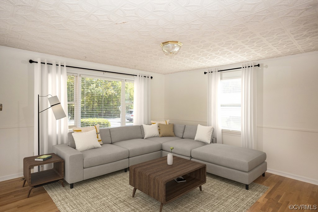 Living room with light hardwood / wood-style flooring. Virtually staged.