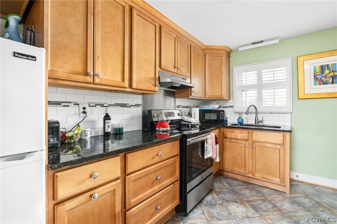Updated kitchen with ceramic tile floors, granite counter top, maple wood cabinets and subway tile backsplash!
