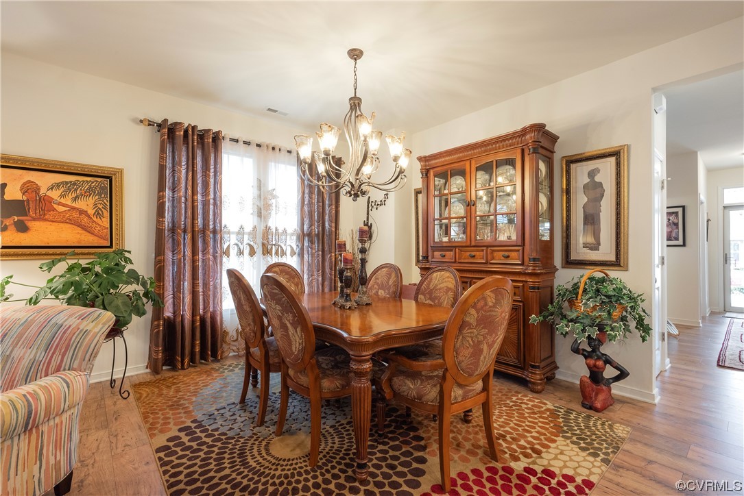 Dining room featuring a notable chandelier and hardwood / wood-style flooring