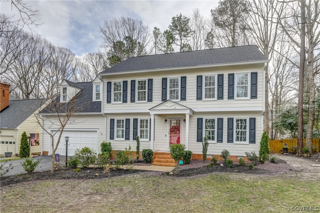 The Pretty White exterior with New Landscaping, Red Front Door, and a Charming Front Porch oozes curb appeal and welcomes you in.