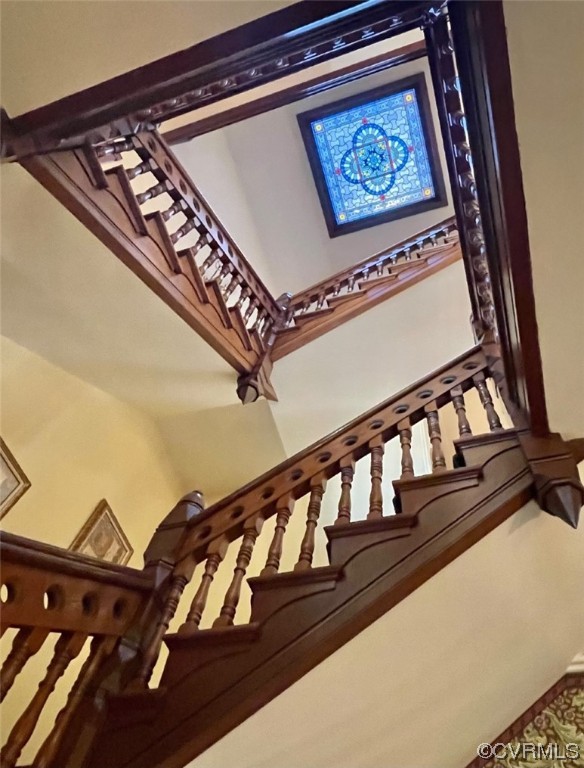 Staircase going up to third floor - note restored stained glass