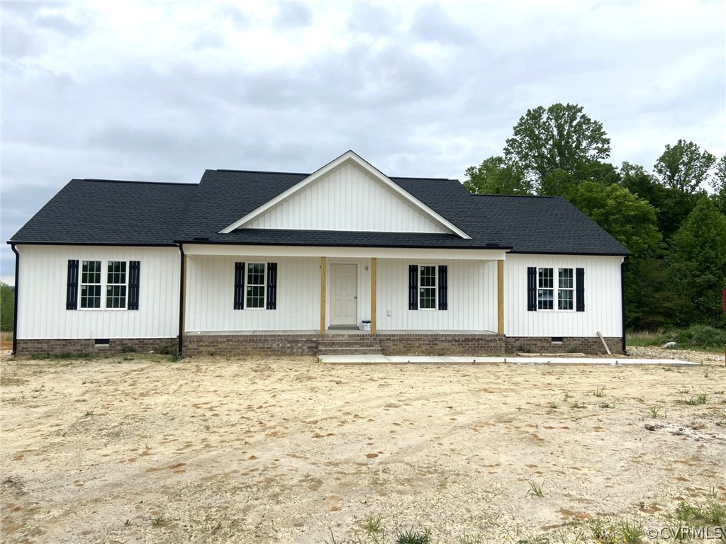Property under construction with covered porch