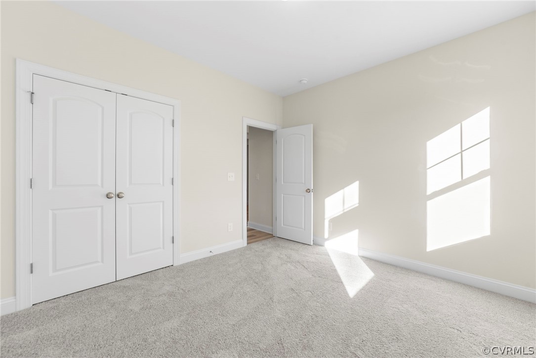 Photo represents the plan, not the actual home. Design selections may vary. Split bedroom design. Bedrooms 2 and 3 with carpet and double door closet.