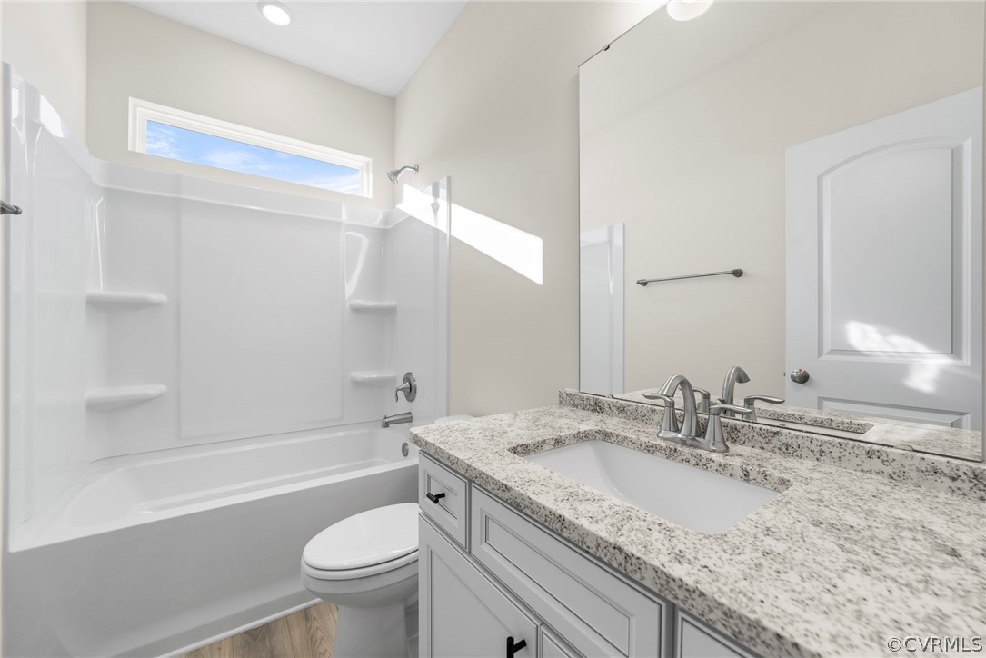 Photo represents the plan, not the actual home. Design selections may vary. Full hall bath, laundry room and a covered rear patio complete the look.