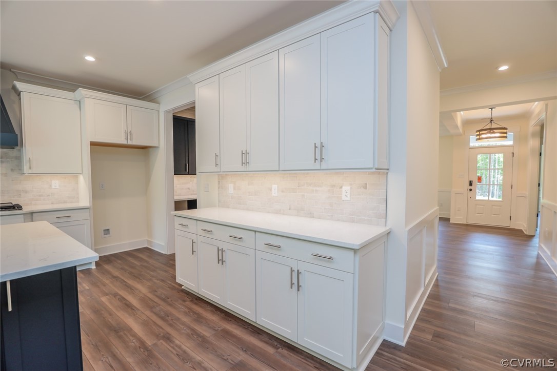 Photo represents the plan, not the actual home. Design selections may vary. Designer kitchen w/ island, large butler's pantry, wall oven/microwave combo, quartz countertops, kitchen backsplash, stainless steel appliances and EVP floors.