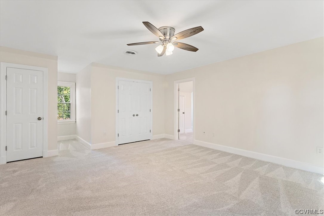 Bedroom room featuring light carpet and ceiling fan