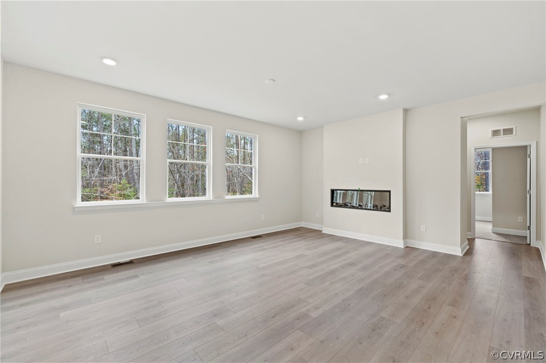 Unfurnished living room with light wood-type flooring