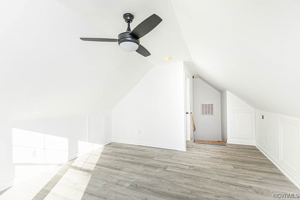Bonus room featuring lofted ceiling, ceiling fan, and light hardwood / wood-style flooring