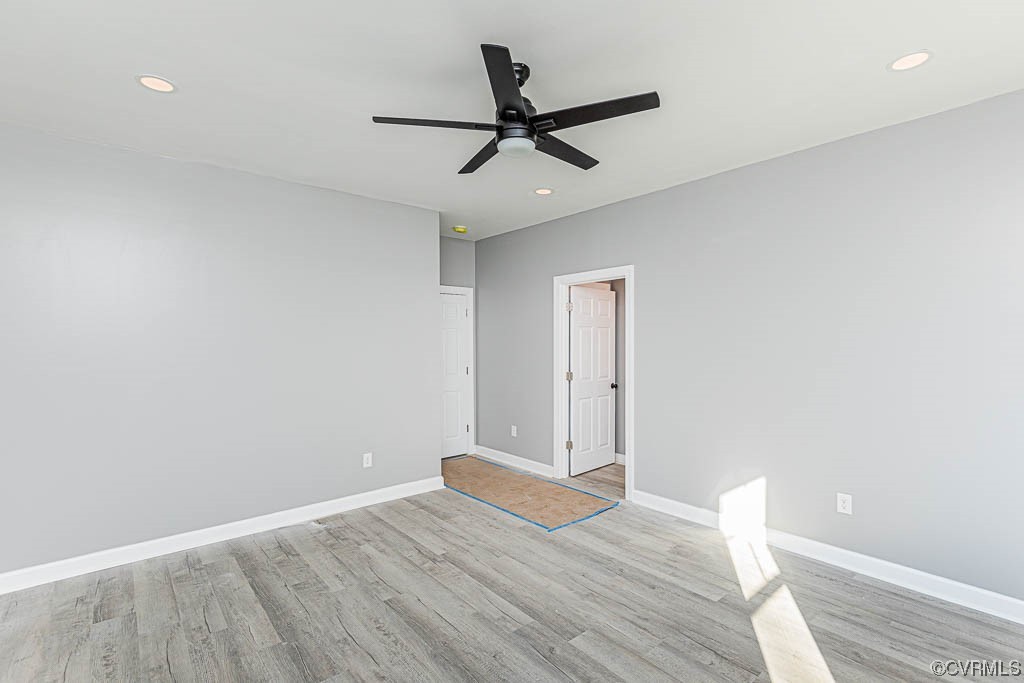 Empty room featuring light hardwood / wood-style flooring and ceiling fan