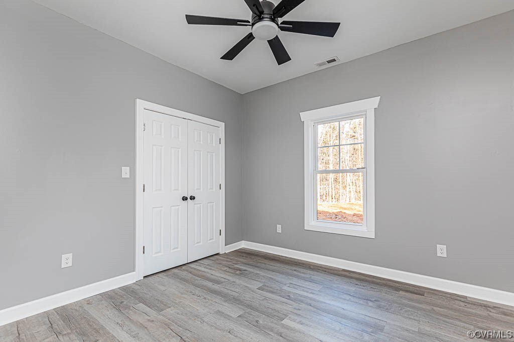 Spare room featuring ceiling fan and light hardwood / wood-style floors