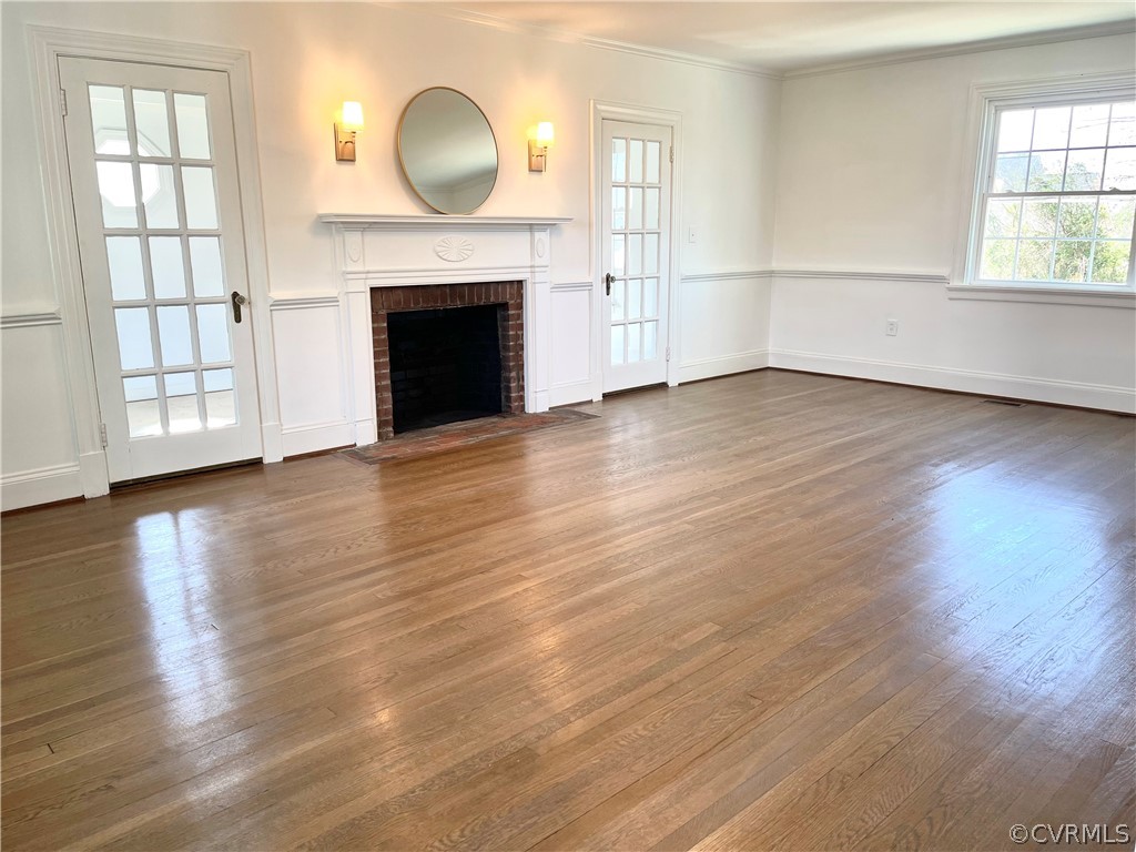 Living room with lots of natural light, refinished original hardwood floors, and glass doors to adjacent study 15x23