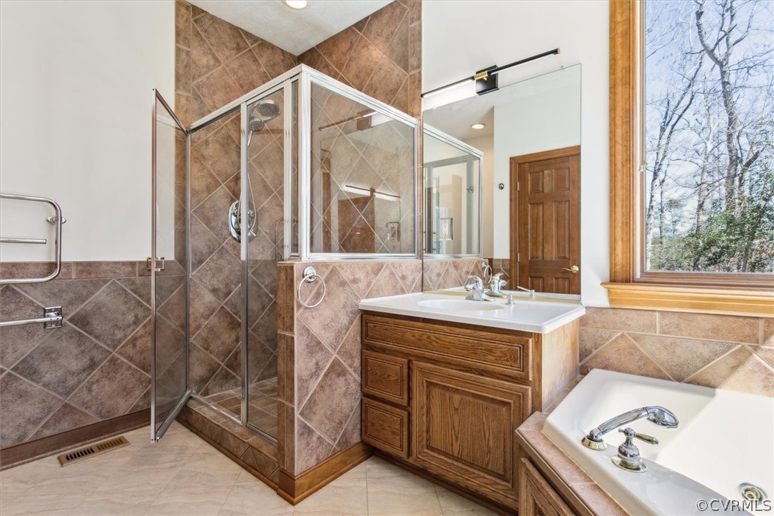 Primary Bath - New Lighting, Towel Warmer, Custom Tile Shower, Jetted Tub, Large Windows for Natural Light and to enjoy the Views of the Waterfront.