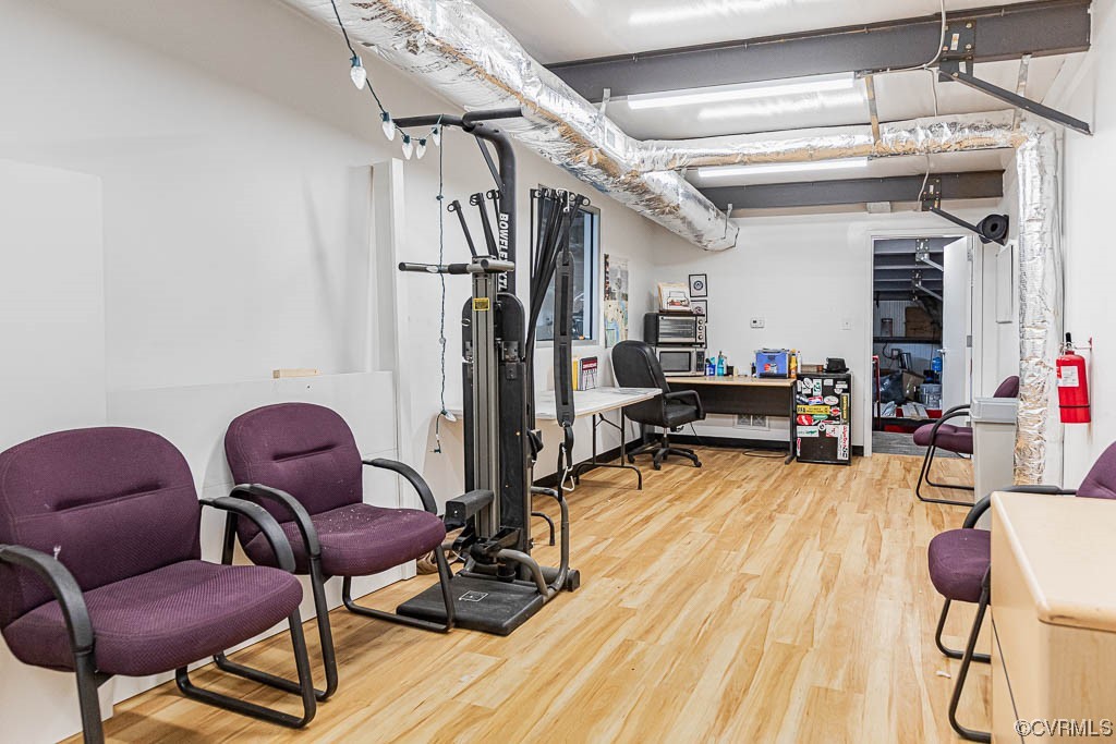Workout room with light wood-type flooring