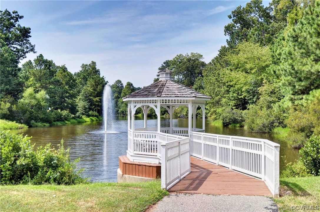 View of dock with a gazebo and a water view