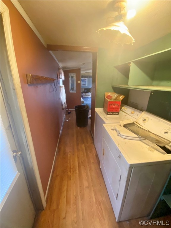 Bathroom featuring ornamental molding, independent washer and dryer, and hardwood / wood-style flooring