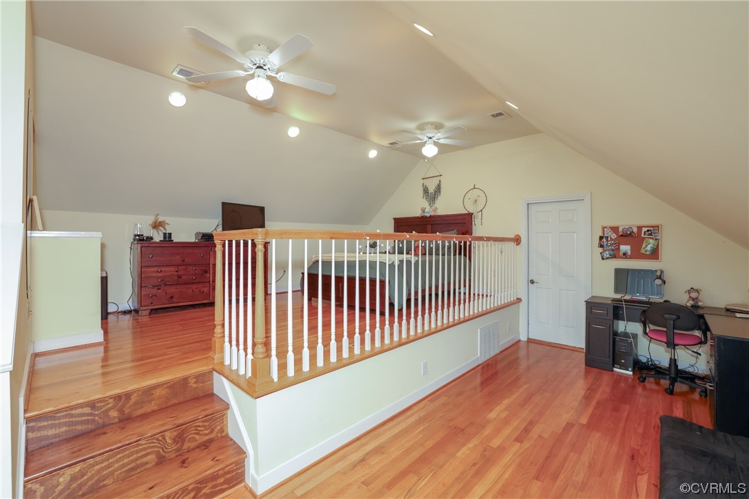 Third floor bedroom with walk in closet and private bath, hardwood floors, and attic access