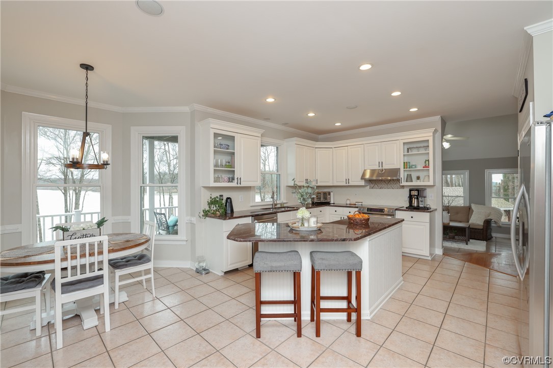 Gorgeous!!   Expansive granite island with seating, 2 pantries, bay window with lake views, tile flooring, recessed lighting, great space for guests to gather