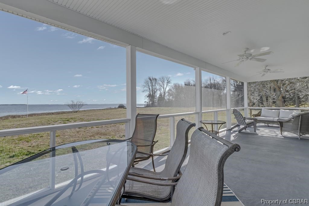 Screened Porch / solarium with a water view and ceiling fan